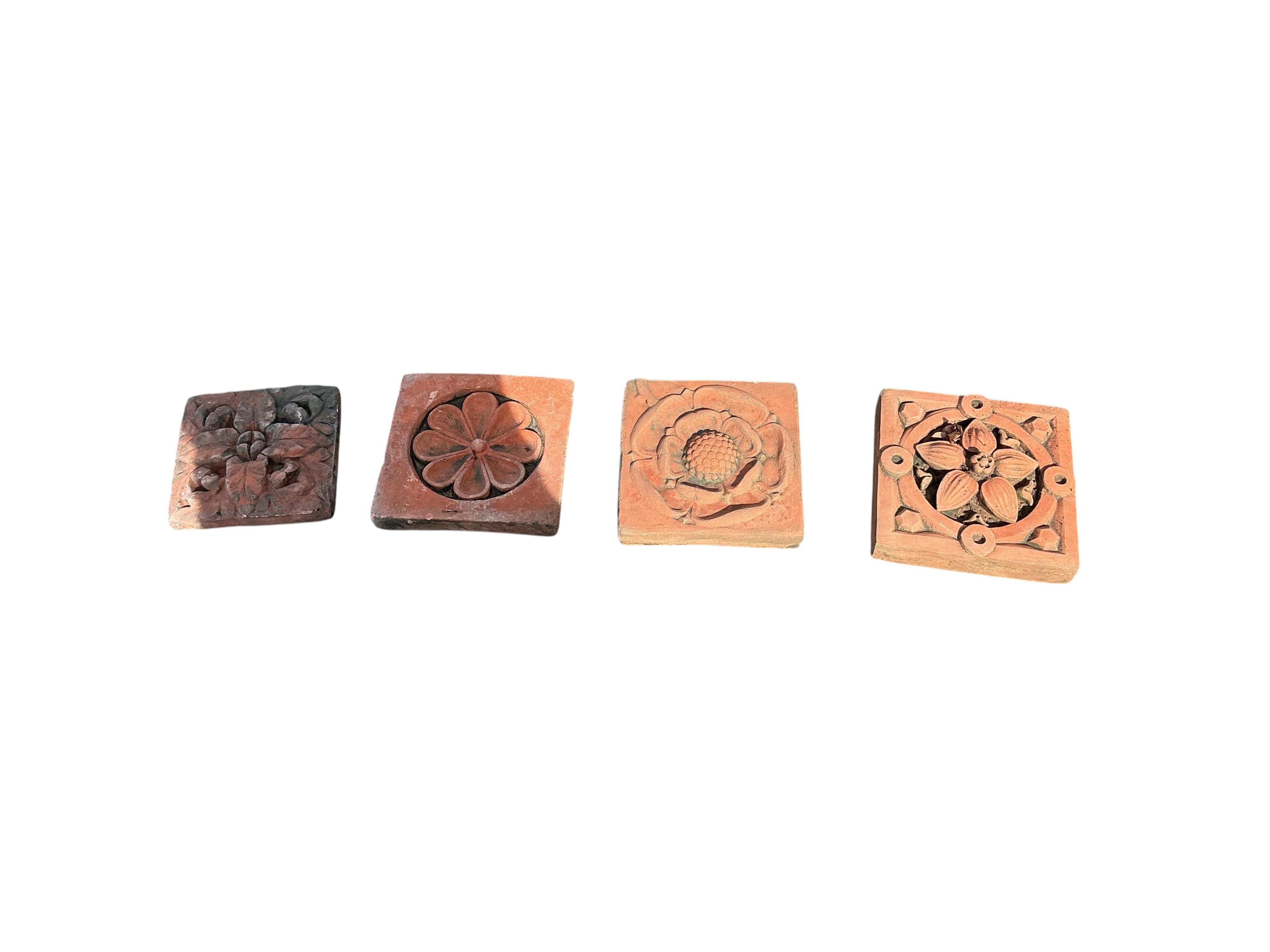 Eleven terracotta tiles, largest 22 x 24cm